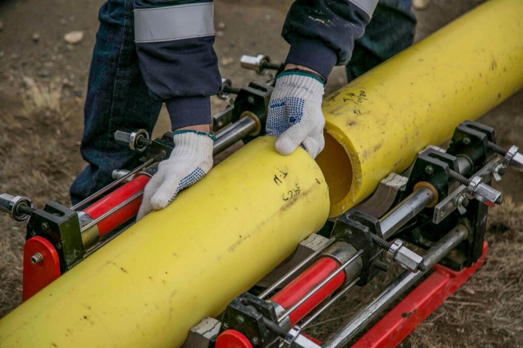 Technician performing pipe repair work on a residential wastewater line