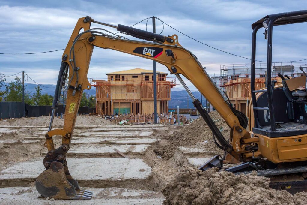 Excavator at a residential construction site for septic tank replacement